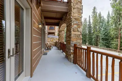 a porch of a home with a stone wall at 3059 The Timbers condo in Keystone