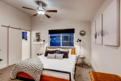 a bedroom with a bed and a ceiling fan at Old Town Swank - Brand New To Brewery District! in Fort Collins