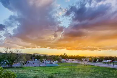 a view of a park with a cloudy sky at Old Town Swank - Brand New To Brewery District! in Fort Collins