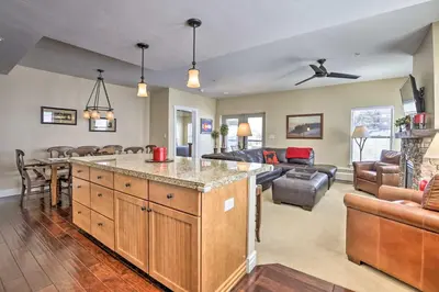 a kitchen and living room with a couch at Ski-InandSki-Out Granby Base Camp Escape with Balcony in Granby