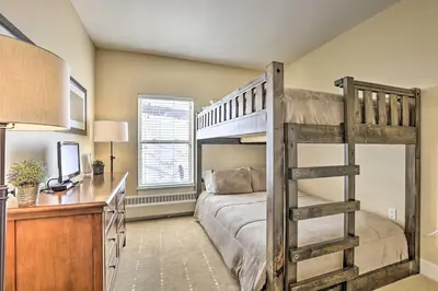 a bedroom with a bunk bed and a desk at Ski-InandSki-Out Granby Base Camp Escape with Balcony in Granby