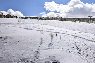 a field covered in snow with a fence at Ski-InandSki-Out Granby Base Camp Escape with Balcony in Granby
