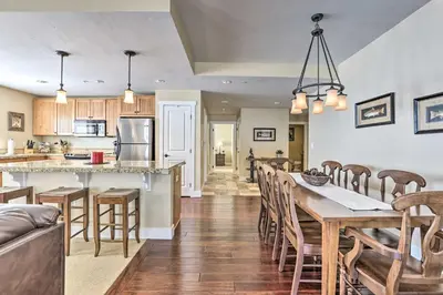 a kitchen and living room with a table and chairs at Ski-InandSki-Out Granby Base Camp Escape with Balcony in Granby