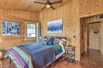 a bedroom with a bed and a ceiling fan at 2 Mi to St Marys Glacier Modern Cabin with Hot Tub in Idaho Springs