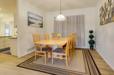 a dining room with a wooden table and chairs at Spacious Thornton Home 15 Mi to Downtown Denver! in Thornton