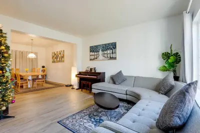 a living room with a couch and a christmas tree at Spacious Thornton Home 15 Mi to Downtown Denver! in Thornton