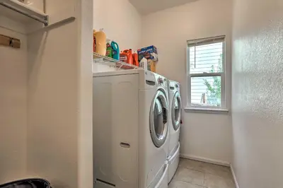 a laundry room with a washer and dryer at Spacious Thornton Home 15 Mi to Downtown Denver! in Thornton