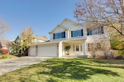 a large white house with a driveway at Spacious Thornton Home 15 Mi to Downtown Denver! in Thornton