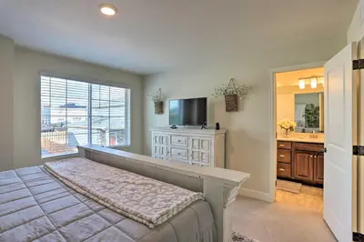 a bedroom with a bed and a television and a sink at Modern Aurora Getaway 22 Mi to Downtown Denver in Watkins