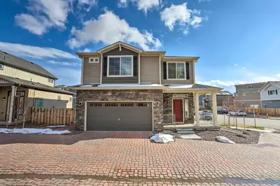 a house on a brick driveway with a garage at Modern Aurora Getaway 22 Mi to Downtown Denver in Watkins