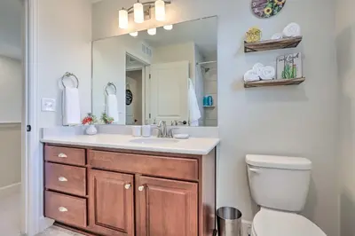 a bathroom with a sink and a toilet and a mirror at Modern Aurora Getaway 22 Mi to Downtown Denver in Watkins