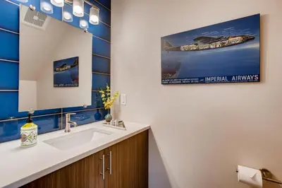 a bathroom with a sink and a mirror at Elegant Townhome near Old Town, Breweries and River! in Fort Collins