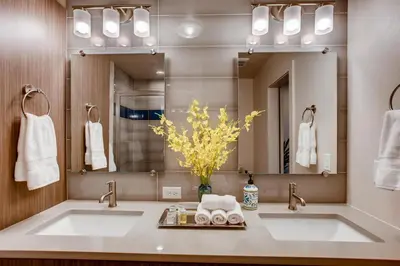 a bathroom with two sinks and a large mirror at Elegant Townhome near Old Town, Breweries and River! in Fort Collins