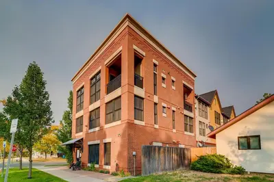 a red brick building on the side of a street at Old Town Loft Oasis with Amazing Rooftop Deck! in Fort Collins
