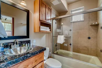 a bathroom with a sink and a shower and a toilet at Old Town Loft Oasis with Amazing Rooftop Deck! in Fort Collins