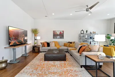 a living room with a couch and a tv at The Penthouse Loft in the Heart of Old Town! in Fort Collins