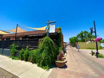 a building on a sidewalk with plants and flowers at The Penthouse Loft in the Heart of Old Town! in Fort Collins