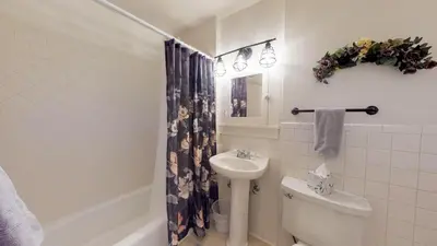a bathroom with a toilet and a sink at Mulberry Place - A Charming Cottage Near Old Town! in Fort Collins