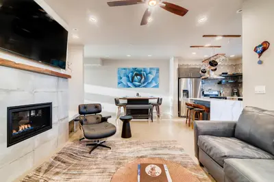 a living room with a couch and a fireplace at Fancy Townhome near Old Town, Breweries and River! in Fort Collins