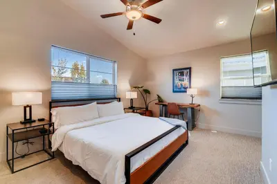 a bedroom with a bed and a ceiling fan at Fancy Townhome near Old Town, Breweries and River! in Fort Collins