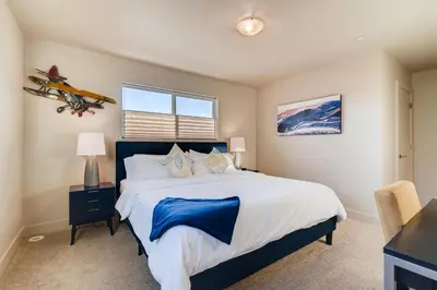 a bedroom with a large bed and a window at Fancy Townhome near Old Town, Breweries and River! in Fort Collins