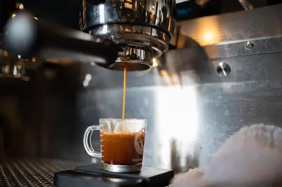 a person is making a cup of coffee at Gravity Haus Winter Park in Winter Park