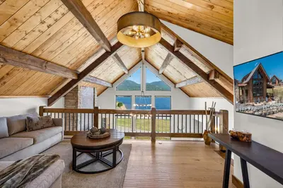 a living room with a couch and a table at Anglers Paradise - Located on Lake Estes, Fireplace, Two Large Patios, and Private Jacuzzi in Estes Park