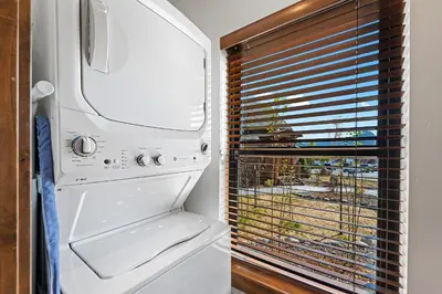 a white refrigerator in a kitchen with a window at Anglers Paradise - Located on Lake Estes, Fireplace, Two Large Patios, and Private Jacuzzi in Estes Park
