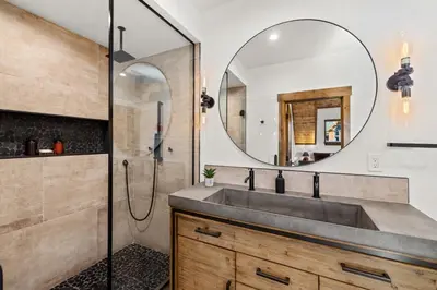 a bathroom with a sink and a mirror at Anglers Paradise - Located on Lake Estes, Fireplace, Two Large Patios, and Private Jacuzzi in Estes Park