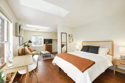 a bedroom with a large bed and a desk at Boulder Guest House in Boulder