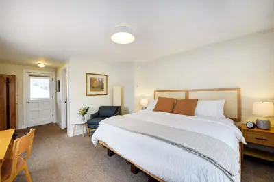 a bedroom with a large bed and a table and chair at Boulder Guest House in Boulder