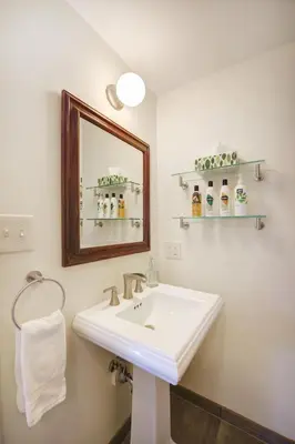 a bathroom with a white sink and a mirror at Boulder Guest House in Boulder
