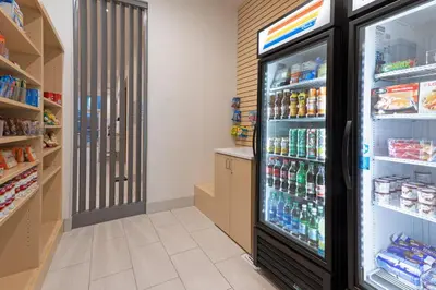 a refrigerator filled with lots of drinks in a store at Holiday Inn Express & Suites - Firestone - Longmont by IHG in Longmont