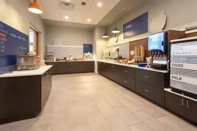 a kitchen with counters and a food court in a store at Holiday Inn Express & Suites - Firestone - Longmont by IHG in Longmont