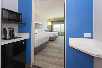 a hotel room with two beds and a bathroom at Holiday Inn Express & Suites - Firestone - Longmont by IHG in Longmont