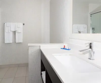 a white bathroom with a sink and a mirror at Holiday Inn Express & Suites - Firestone - Longmont by IHG in Longmont