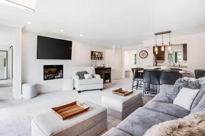 a living room with a couch and a table at Modern High Country Haus in Winter Park