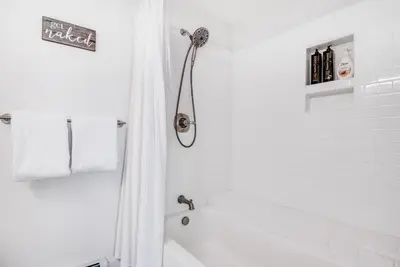 a white bathroom with a tub and a shower at Modern High Country Haus in Winter Park