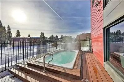 a hot tub on the deck of a house at Modern High Country Haus in Winter Park