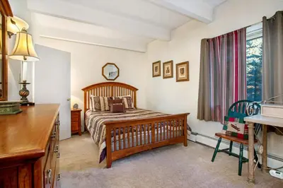 a bedroom with a bed and a desk and a window at Lakeview A-303 - Dillon in Dillon