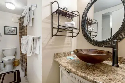 two pictures of a bathroom with a sink and a mirror at Lakeview A-303 - Dillon in Dillon