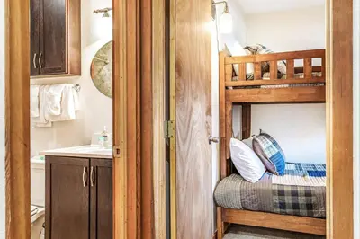 a small bathroom with a bunk bed and a sink at Snowscape 06 - Wildernest in Silverthorne
