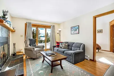 a living room with two couches and a table at Snowscape 06 - Wildernest in Silverthorne