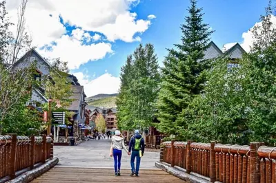 two people walking down a boardwalk in a town at Snowscape 06 - Wildernest in Silverthorne
