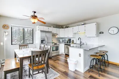 a kitchen and dining room with a table and chairs at 11 Mi to Keystone Resort Condo in Silverthorne in Silverthorne