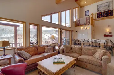 a living room with couches and a table at Slopeside Sanctuary - Penthouse Less Than 1 Mi to Lifts! in Winter Park