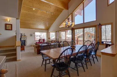 a dining room with a wooden table and chairs at Slopeside Sanctuary - Penthouse Less Than 1 Mi to Lifts! in Winter Park