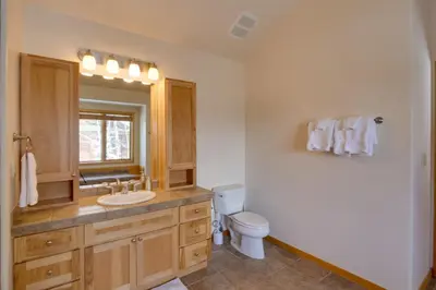 a bathroom with a sink and a toilet and a mirror at Slopeside Sanctuary - Penthouse Less Than 1 Mi to Lifts! in Winter Park