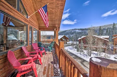 a porch with red chairs and an american flag at Slopeside Sanctuary - Penthouse Less Than 1 Mi to Lifts! in Winter Park