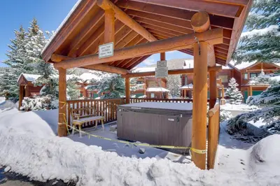 a wooden gazebo with a hot tub in the snow at Slopeside Sanctuary - Penthouse Less Than 1 Mi to Lifts! in Winter Park